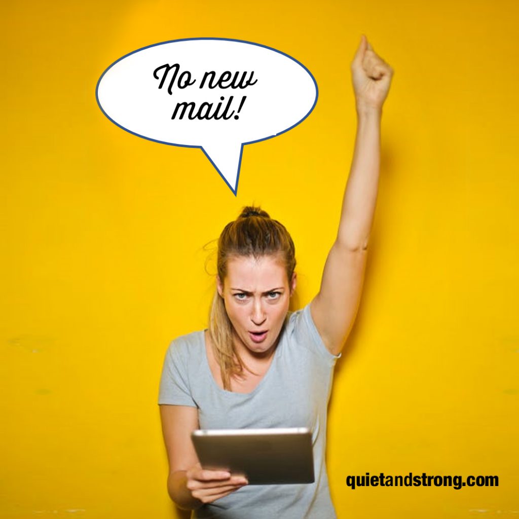 A telecommuting woman holds up a tablet displaying a speech bubble indicating no new emails.