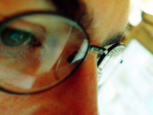 A person wearing glasses, eliminating worry.