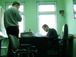 Two introverts facing challenges with communication while sitting at a desk in an office.