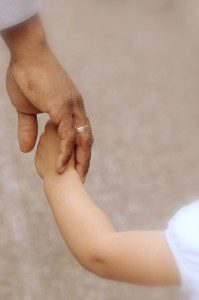 An introverted man holding a little girl's hand while parenting an extroverted child.