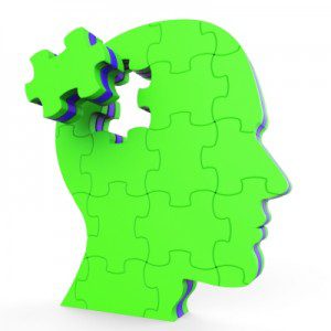 A green puzzle piece is missing from the head of an introverted person.