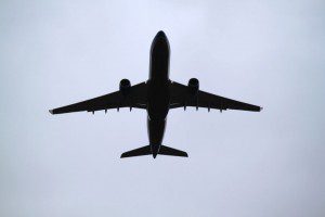 An introverted airplane soars through a cloudy sky.
