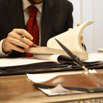 A man in a suit staying calm and focused while reading a book.