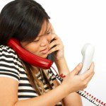A woman chooses not to be overwhelmed while holding and talking on her phone.