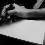 An isolated hand gripping a pen, plagued by writer's block.