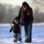 A woman and child, reflecting on nature vs nurture, silently explore the snow-covered landscape.