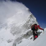 A man is setting goals to climb up a snow covered mountain in 2018.