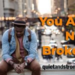 A man embracing his inner power on a ledge with empowering words.