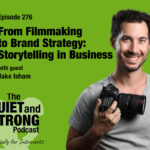 A man holding a camera stands in front of a green background with text promoting episode 276 of The Quiet and Strong Podcast featuring guest Jake Isham.